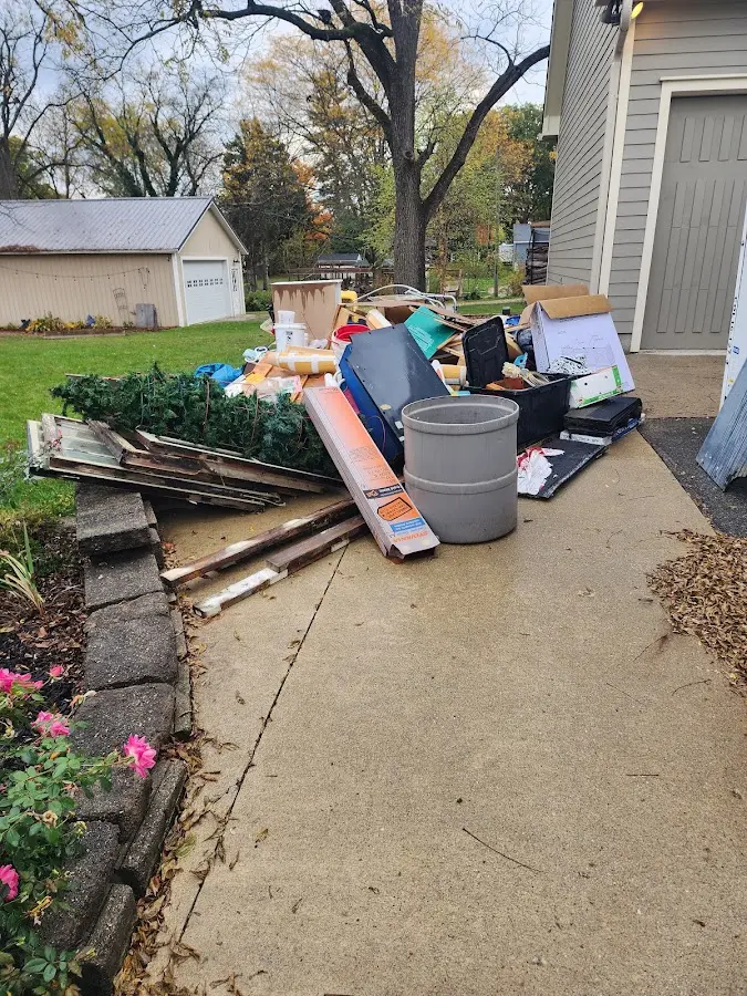 Dumpster being loaded with debris for Estate Cleanout Dumpster Rental in Anacortes